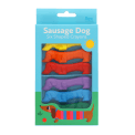 Set of six sausage dog-shaped crayons in yellow, purple, red, blue, green, and orange in packaging.