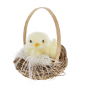 A fluffy yellow chick decoration sitting in a small wicker basket with an egg.