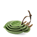 stackable ceramic measuring spoons shaped like green leaves with brown stem handles