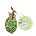 Stackable ceramic measuring spoons shaped like green leaves with brown stem handles with tag