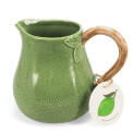 Green ceramic jug with textured surface and a curved brown handle with tag