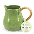 Green ceramic jug with textured surface and a curved brown handle with tag
