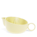 Yellow stoneware lemon squeezer with handle and pouring spout.