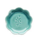 Ceramic trinket dish with a scalloped edge and a floral design in the centre.