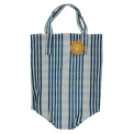 Blue and white striped woven shopping bag with handles and a tag.