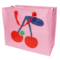 Large pink storage bag with a bold cherry graphic and red handles with tag.