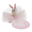 Pink hair clip featuring a small fabric bunny with embroidered details and tag.
