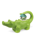 Green crocodile-shaped plastic watering can with raised spikes and a product tag.
