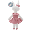 Knitted rabbit toy with long ears, wearing a pink dress with a ruffled collar and a matching bow on one ear