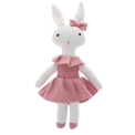 Knitted rabbit toy with long ears, wearing a pink dress with a ruffled collar and a matching bow on one ear