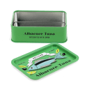 Open mini storage tin with the lid beside it, featuring an illustrated tuna on the lid.