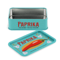 Open mini storage tin with the lid beside it, featuring an illustrated paprika on the lid.