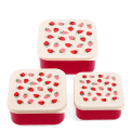 Set of three red square snack boxes with cream lids featuring a strawberry print.