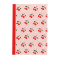 Pink notebook with cherry design on the cover.