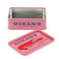 Open pink mini storage tin with the lid beside it, featuring an illustrated lobster on the lid.