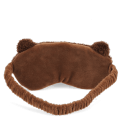 Brown plush teddy bear–shaped travel eye mask with embroidered facial features.