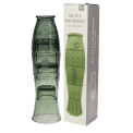 Stacked green glass tumblers placed beside box