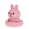 Pink silicone bunny bath toy with upright ears and simple face, in round base
