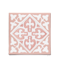 Pink ceramic coaster with white ornate tile pattern.