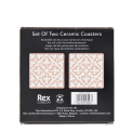 Back of boxed set of two pink ceramic coasters with pattern, branding, and barcode.