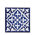 Blue ceramic coaster with embossed pattern.