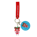 Copilot said:  Cherry girl bag charm with red cherry hat, pink outfit, silicone wrist strap and keyring with tag.