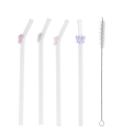 Four reusable glass drinking straws with colourful bow toppers and cleaning brush