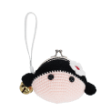 Crochet girl-shaped coin purse with a metal clasp and hanging bell charm.