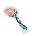 White ceramic spoon rest with blue fish design.
