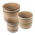 Set of three round seagrass baskets in assorted sizes.