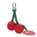 Cherry-shaped coin purse with zip compartments, green strap and gold-tone keychain with tag.