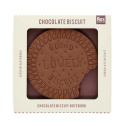 Chocolate biscuit-shaped notebook with bite-mark detail, displayed in retail packaging.