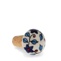 Ceramic and cork bottle stopper with floral and leaf pattern.