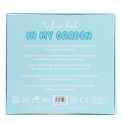 Back cover of Baby First Book with product description, care symbols and safety marks.