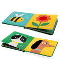 Open touch-and-feel playbook showing colourful illustrated pages with a bee, flower, cat and dog.