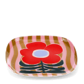 Square metal trinket tray with bold red flower design on a pink striped background.