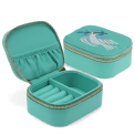 Open jewellery box with embroidered dove design, ring rolls and storage compartments.