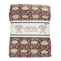 Brown hand block-printed throw with floral pattern, folded in packaging.