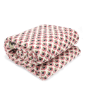 Hand block-printed throw with red floral pattern.