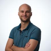  A man smiled at the camera with his arms crossed