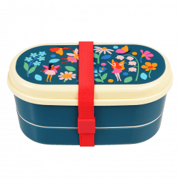 Dark blue kids bento box with cream lid and middle tray plus red elastic strap featuring print of fairies amongst flowers