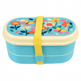 Light blue kids bento box with cream lid and middle tray plus yellow elastic strap featuring print of butterflies amongst flowers