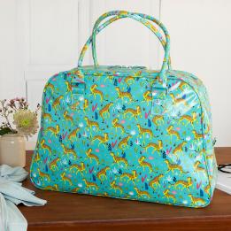 Turquoise oilcloth weekend bag with print of cheetahs