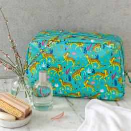 Turquoise oilcloth wash bag with print of cheetahs