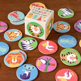 Multi-coloured memory game pieces with illustrations of animals on table with box
