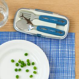 Stainless steel fork and spoon with dark blue plastic handles featuring with pictures of sharks in plastic carry case on table