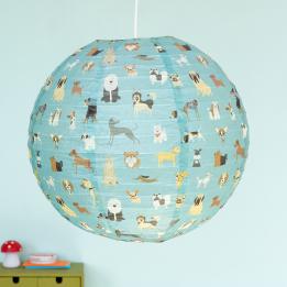 Blue green paper lampshade with dog decoration installed in room