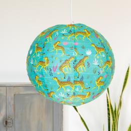Turquoise paper lampshade with cheetah decoration installed in room