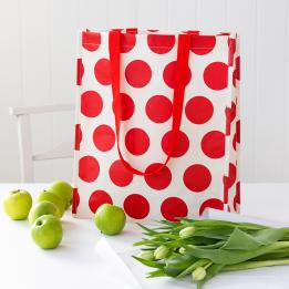 Recycled plastic shopping bag red circles cream background