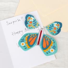 Blue magic butterfly toy placed inside greetings card